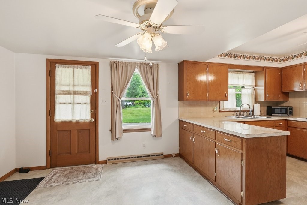 161 Pinehurst Road Munroe Falls, OH 44262 - Photo 16 of 40 Kitchen with wood cabinetry, light-toned countertops, and a tile backsplash