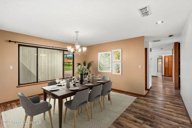 an aerial view of residential house with swimming pool and lawn chairs