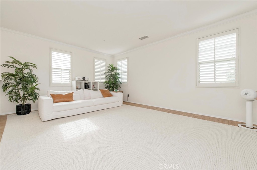 579 Boxwood Lane Azusa, CA 91702 - Photo 13 of 27 a spacious bedroom with a bed and a potted plant
