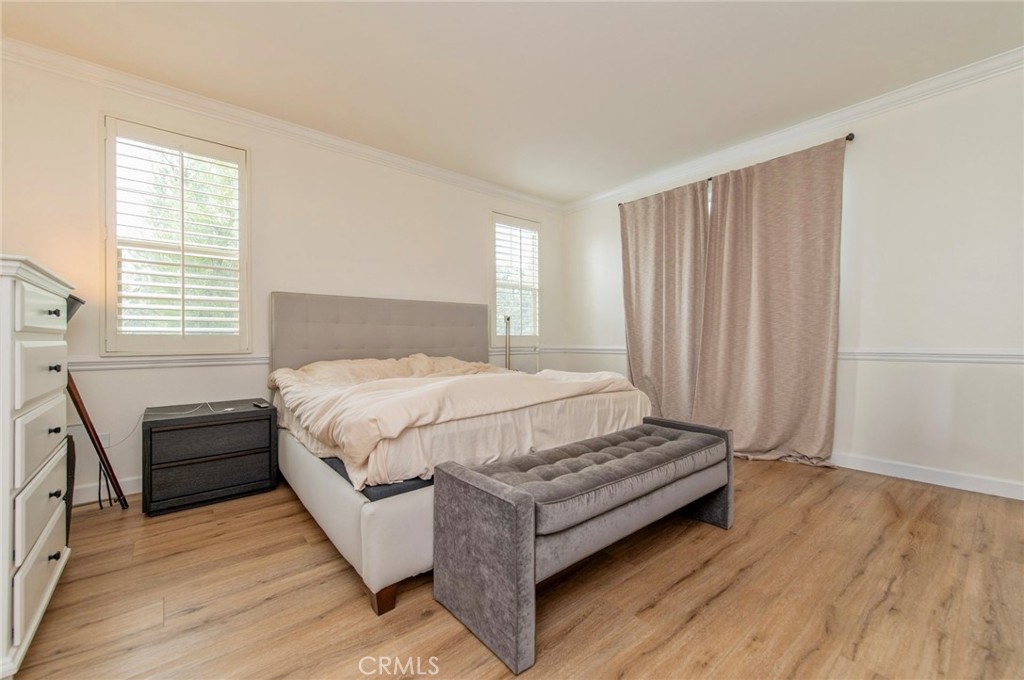 579 Boxwood Lane Azusa, CA 91702 - Photo 15 of 27 a bedroom with a bed and wooden floor