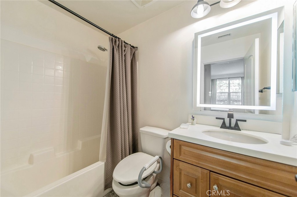 579 Boxwood Lane Azusa, CA 91702 - Photo 21 of 27 a bathroom with a sink a toilet a mirror and shower