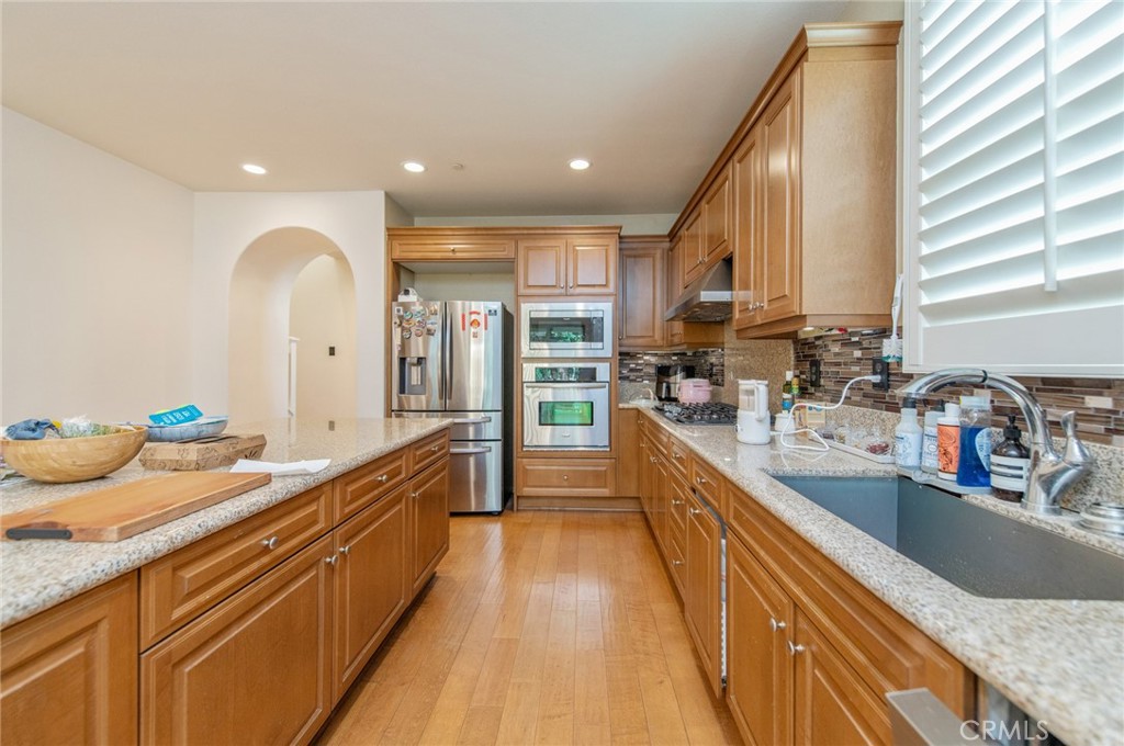 579 Boxwood Lane Azusa, CA 91702 - Photo 7 of 27 a large kitchen with stainless steel appliances a sink a counter top space and a center island