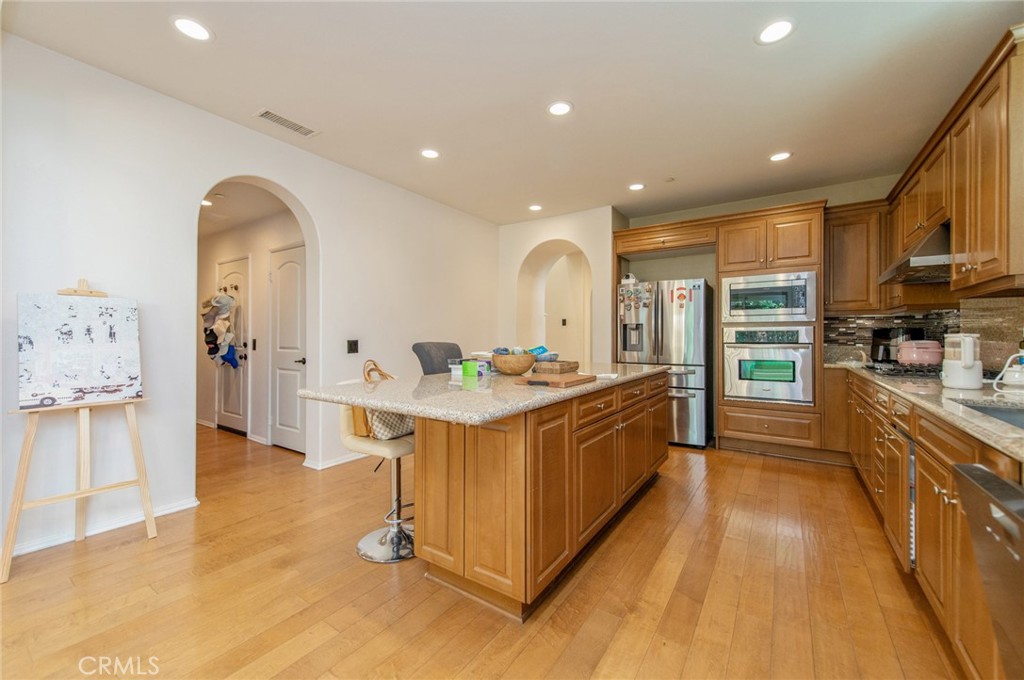 579 Boxwood Lane Azusa, CA 91702 - Photo 8 of 27 a large kitchen with stainless steel appliances kitchen island granite countertop a large counter top and a stove