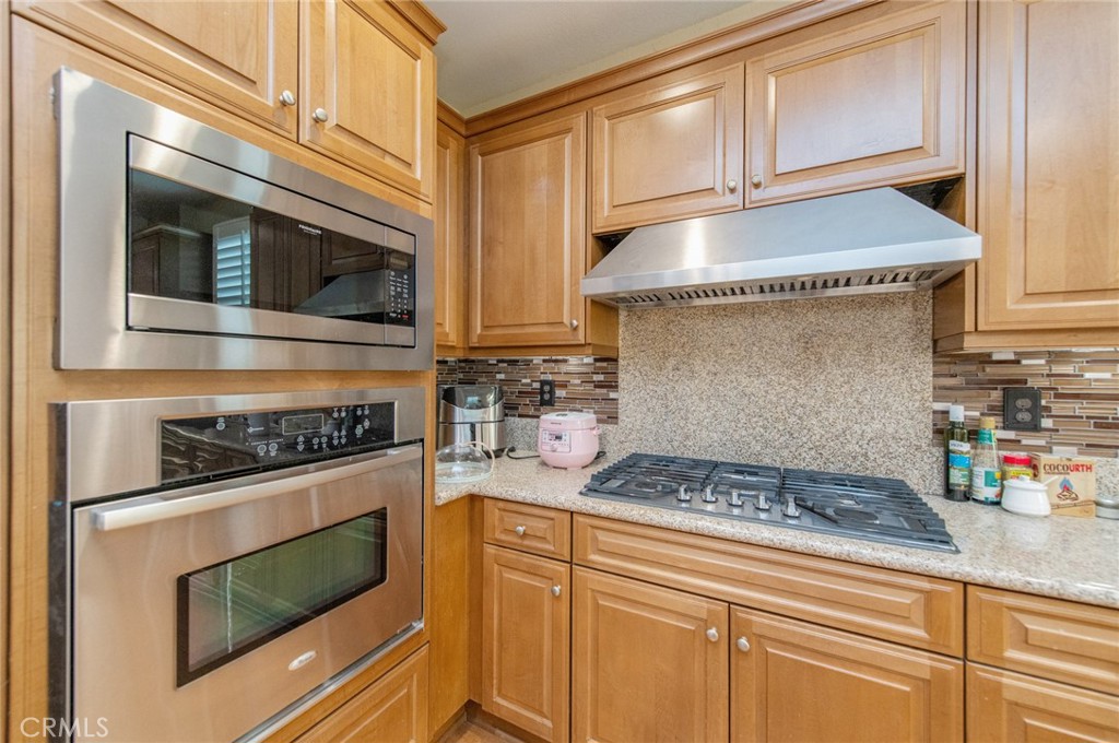 579 Boxwood Lane Azusa, CA 91702 - Photo 9 of 27 a kitchen with stainless steel appliances granite countertop a stove and a microwave