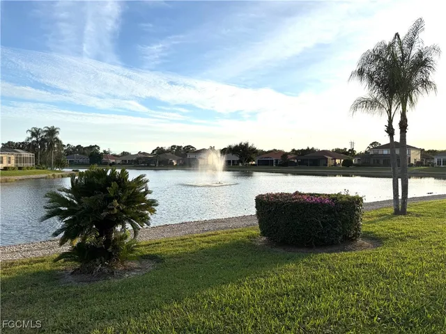 a lake view with a big yard