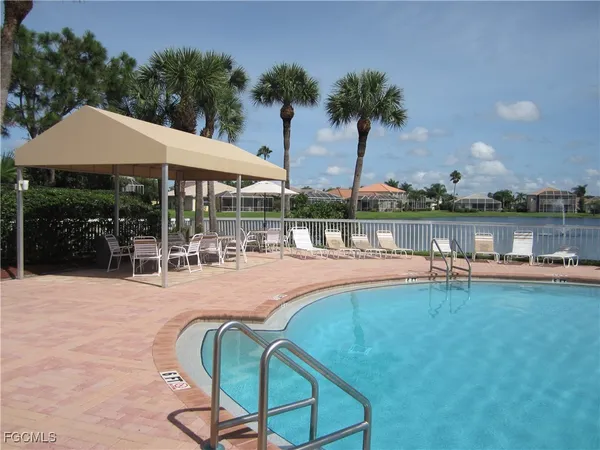 a swimming pool with outdoor seating and yard