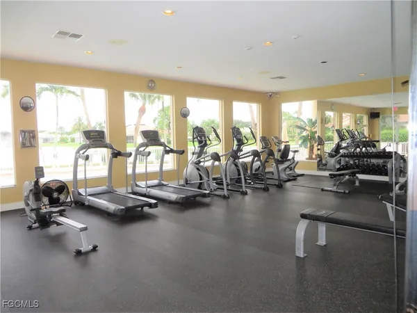 a view of a room with gym equipment and floor to ceiling window
