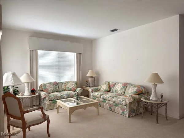 a living room with furniture and a lamp