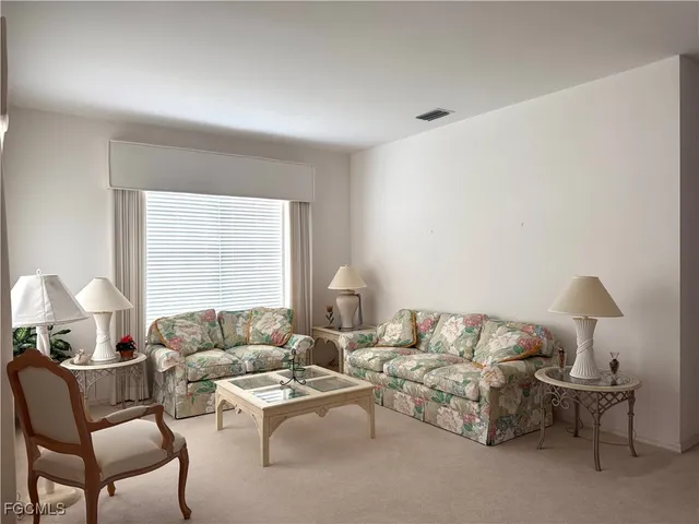 a living room with furniture and a lamp