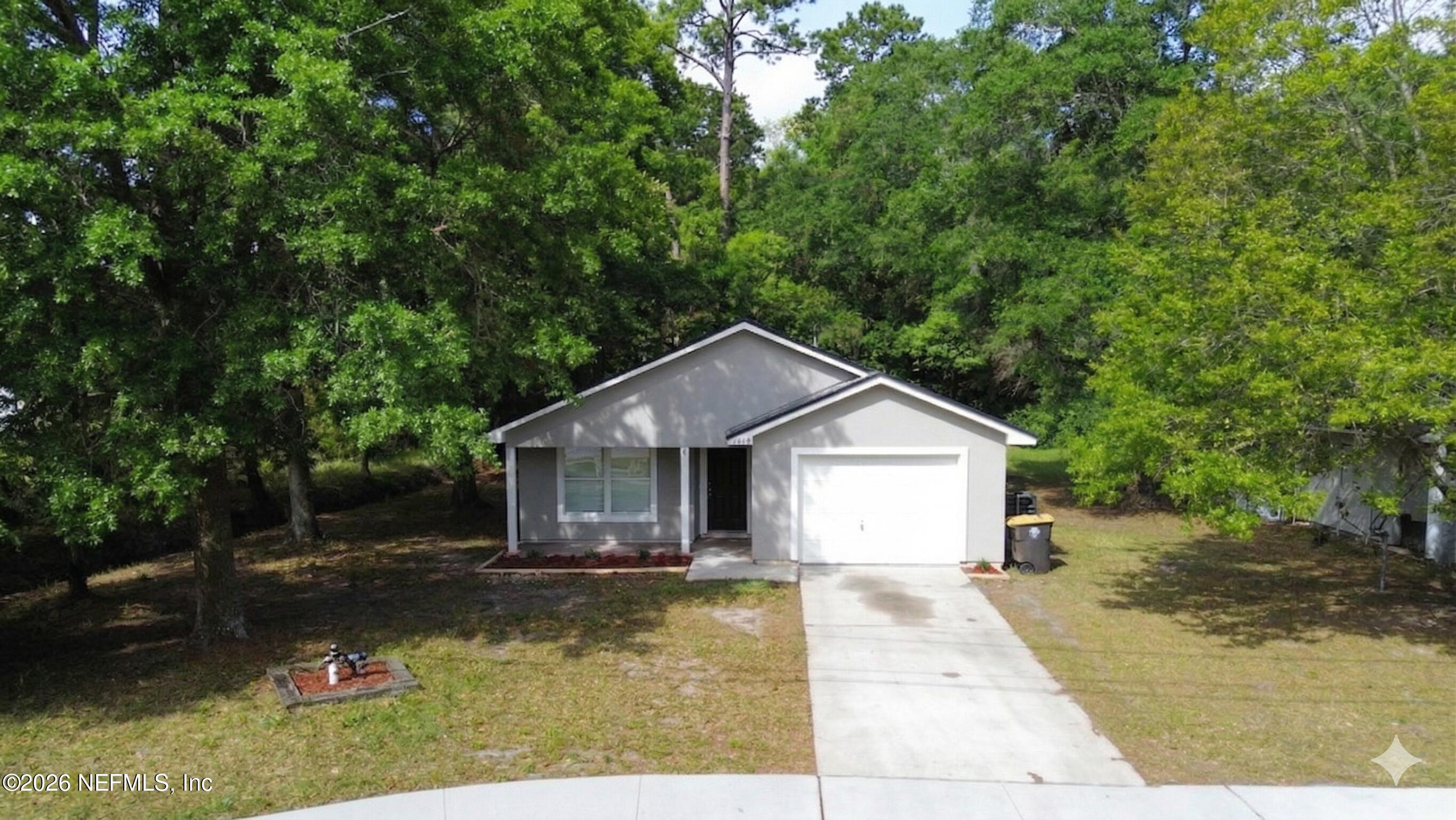 8678 Sibbald Road Jacksonville, FL 32208 - Photo 11 of 24 a front view of a house with a yard and trees