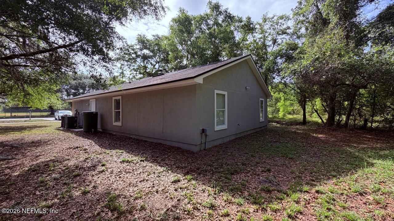 8678 Sibbald Road Jacksonville, FL 32208 - Photo 13 of 24 a view of a house with a backyard
