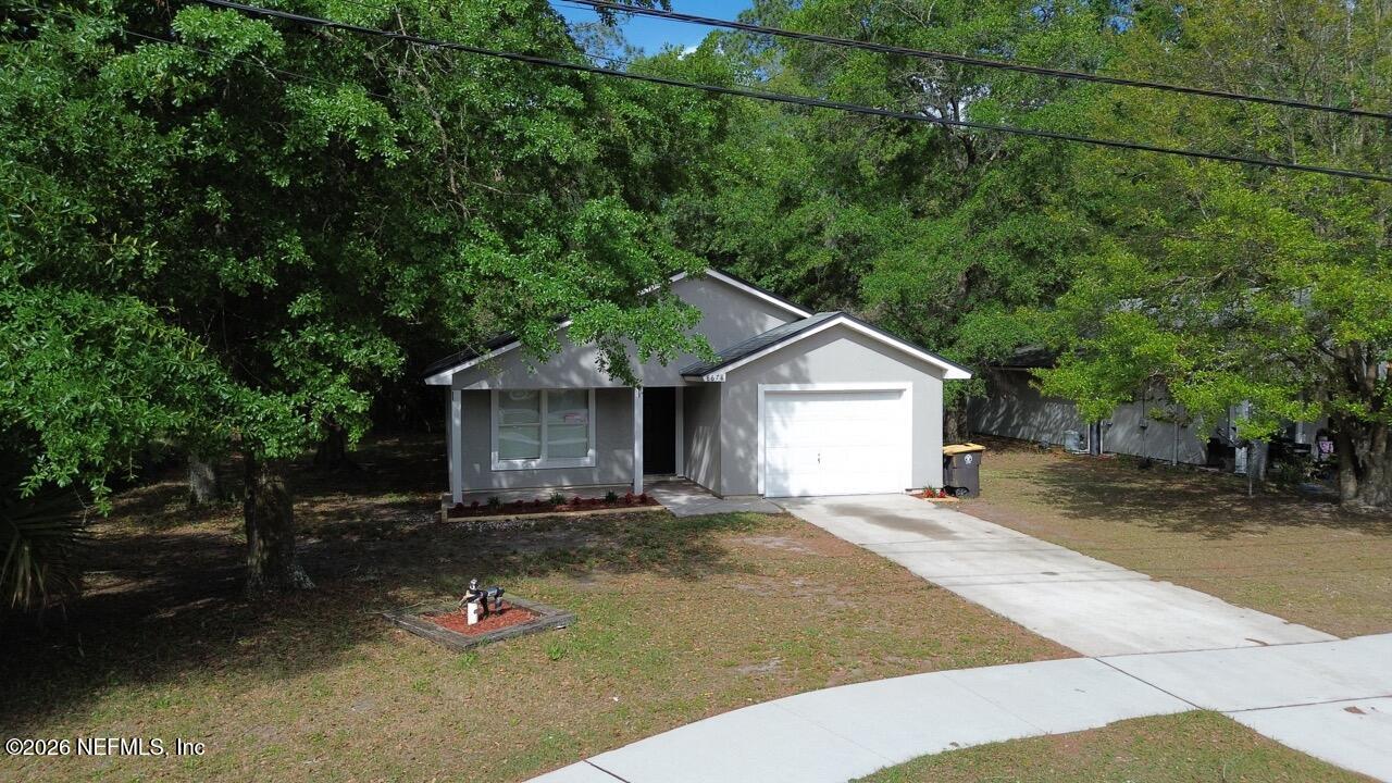 8678 Sibbald Road Jacksonville, FL 32208 - Photo 16 of 24 a view of a house with a yard
