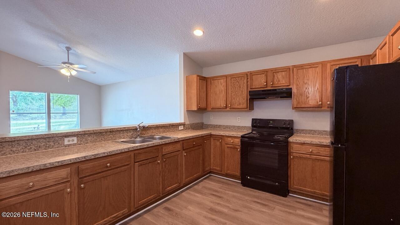 8678 Sibbald Road Jacksonville, FL 32208 - Photo 20 of 24 a kitchen with stainless steel appliances granite countertop a sink stove and refrigerator
