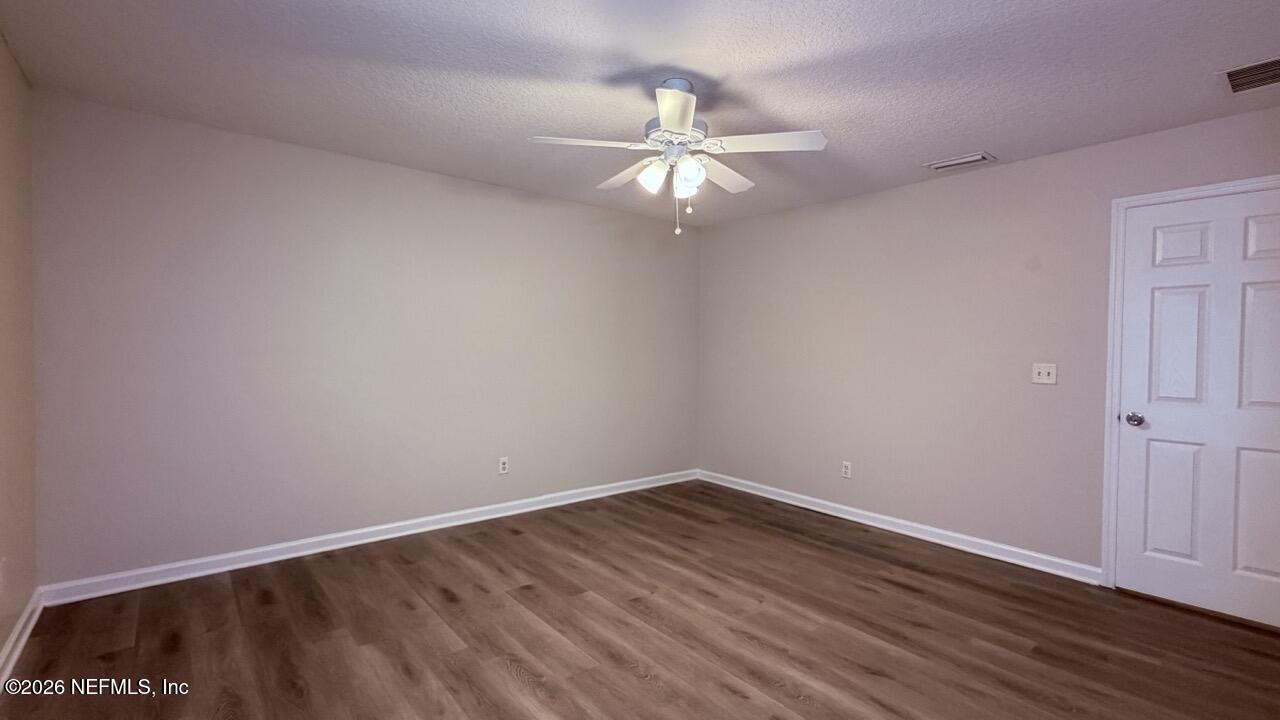 8678 Sibbald Road Jacksonville, FL 32208 - Photo 24 of 24 a view of an empty room with wooden floor