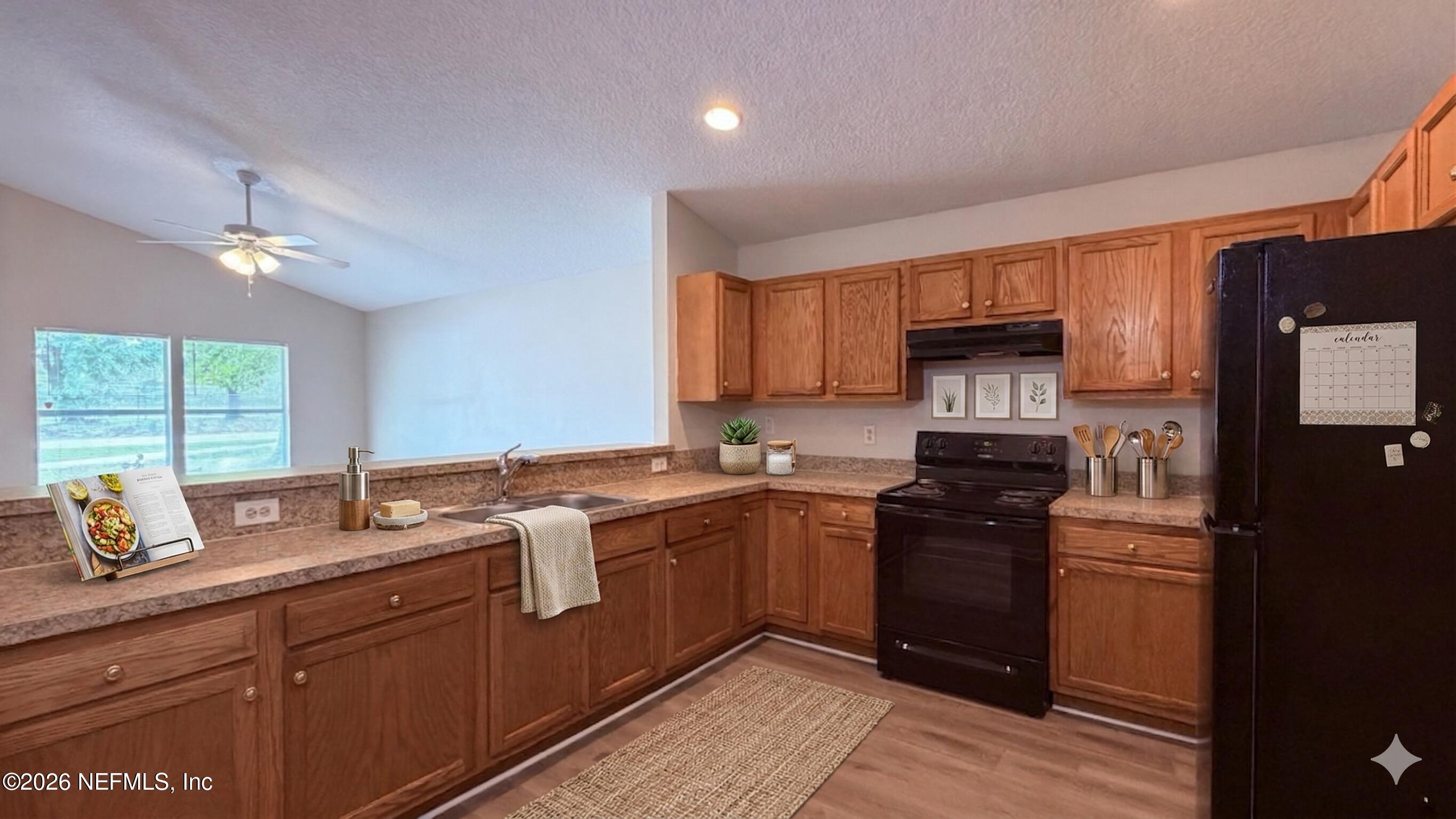 8678 Sibbald Road Jacksonville, FL 32208 - Photo 3 of 24 a kitchen with a sink appliances and cabinets