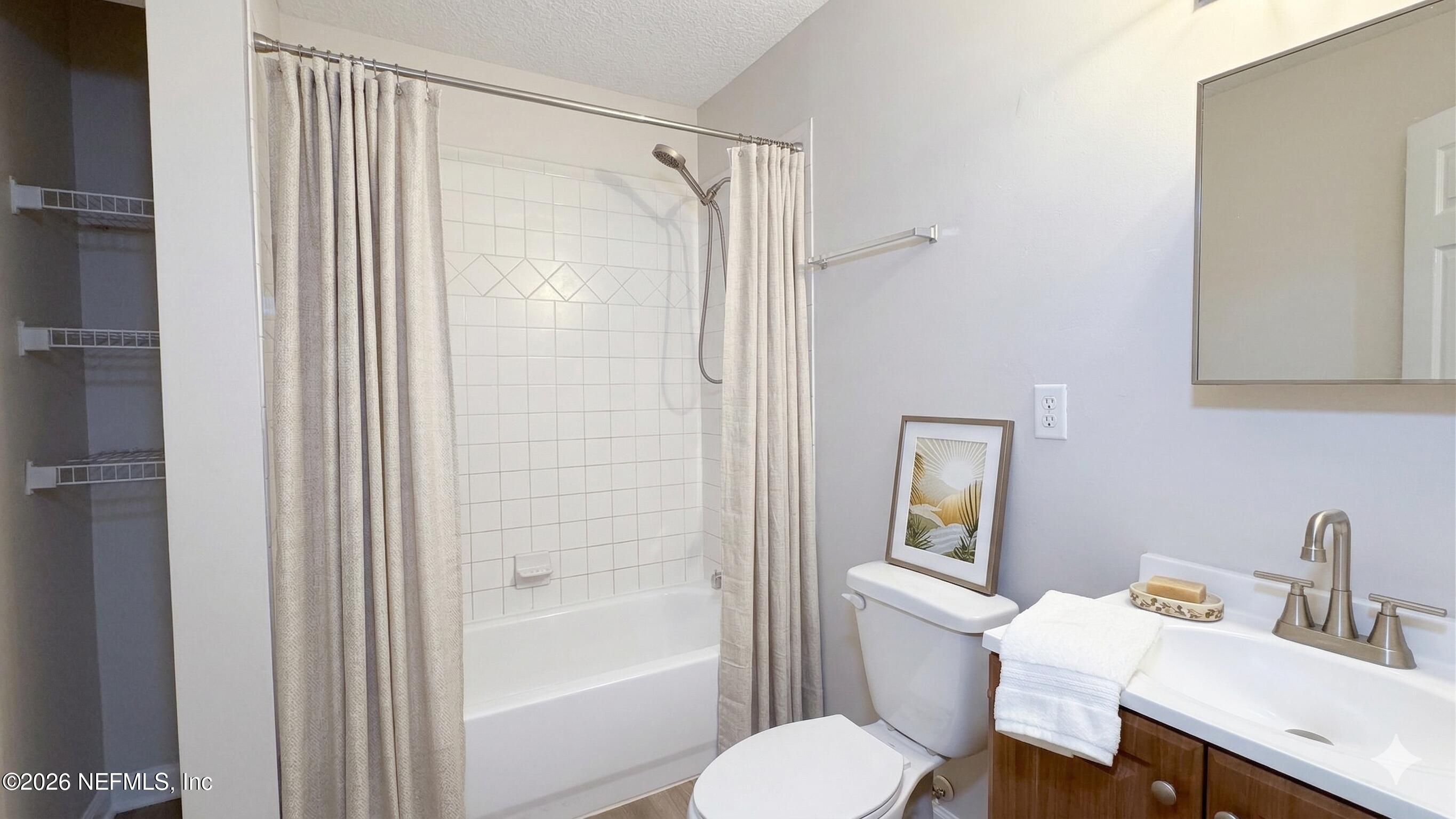 8678 Sibbald Road Jacksonville, FL 32208 - Photo 4 of 24 a bathroom with a sink toilet and shower