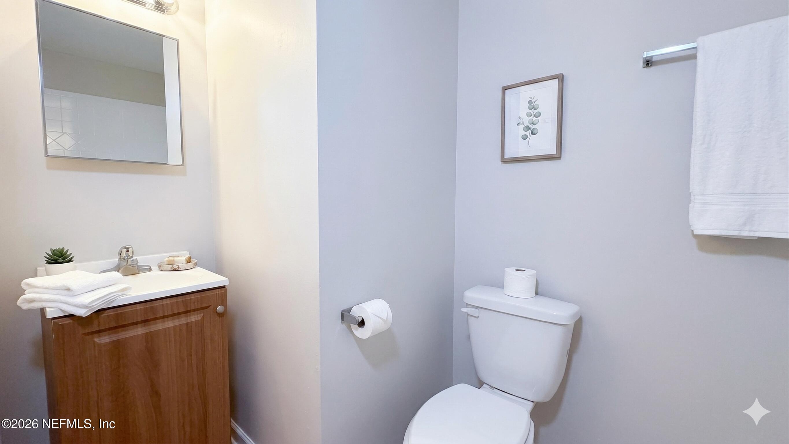 8678 Sibbald Road Jacksonville, FL 32208 - Photo 6 of 24 a bathroom with a toilet sink and mirror
