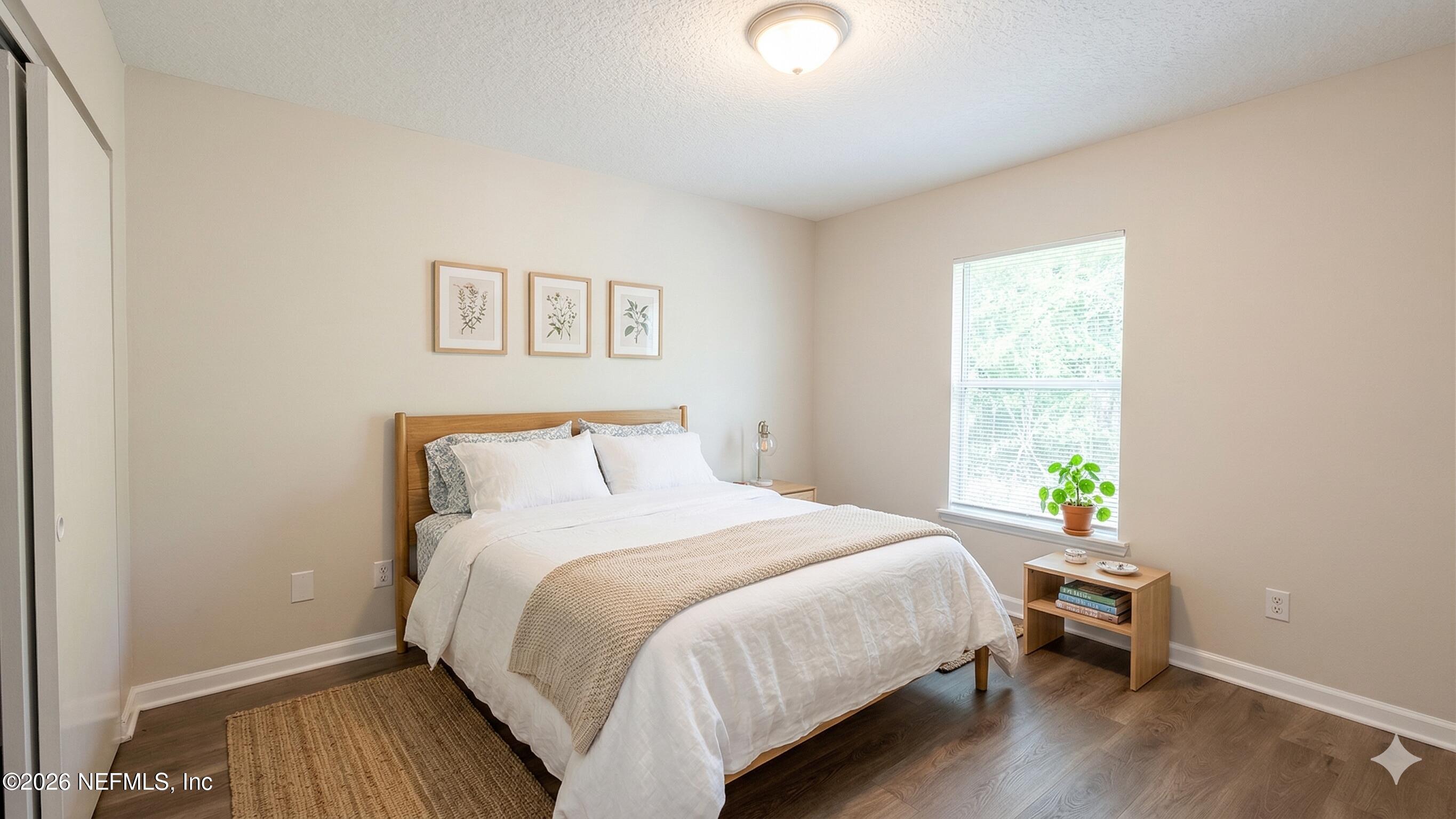 8678 Sibbald Road Jacksonville, FL 32208 - Photo 9 of 24 a bedroom with a bed and table