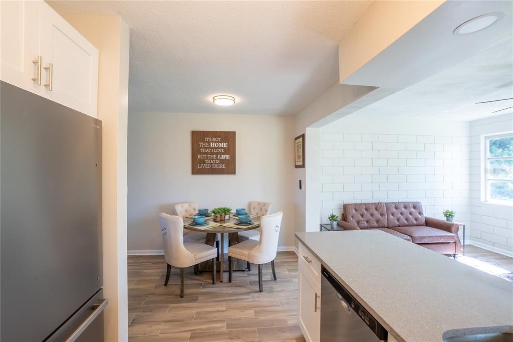 24 Berkley Road Ormond Beach, FL 32176 - Photo 11 of 44 a view of a dining room with furniture and wooden floor