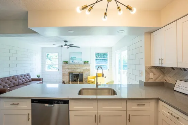 a kitchen with cabinets counter space and dining table