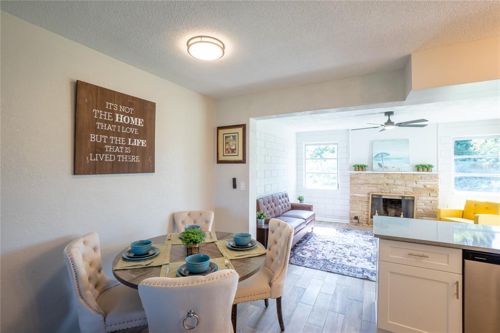 24 Berkley Road Ormond Beach, FL 32176 - Photo 14 of 44 a dining room with furniture a kitchen view and a fireplace