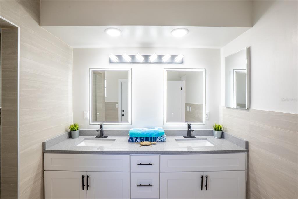 24 Berkley Road Ormond Beach, FL 32176 - Photo 17 of 44 a bathroom with a sink and two mirror