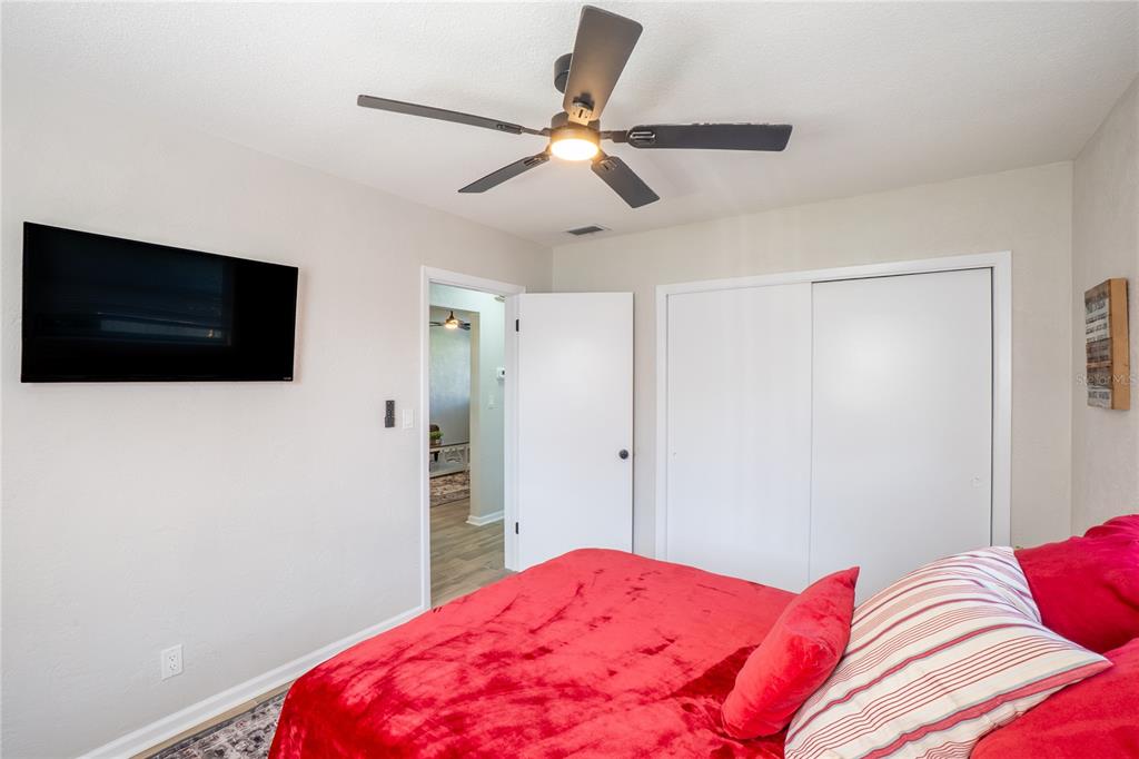 24 Berkley Road Ormond Beach, FL 32176 - Photo 19 of 44 a bedroom with a bed and a flat screen tv