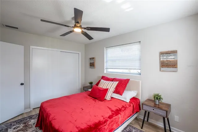 a bedroom with a bed and a chandelier