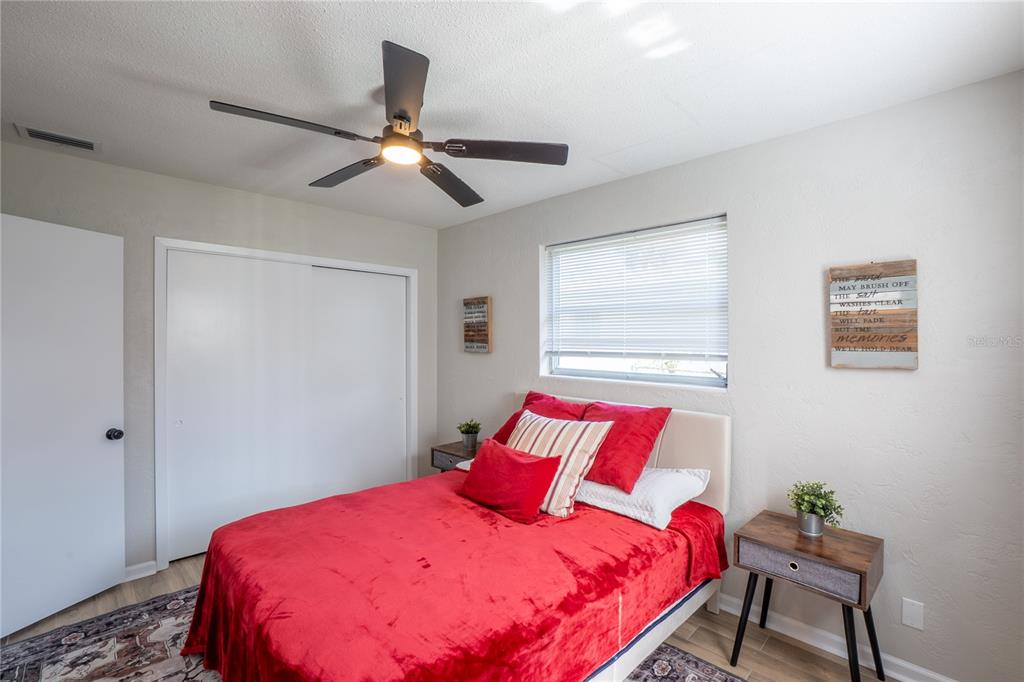 24 Berkley Road Ormond Beach, FL 32176 - Photo 20 of 44 a bedroom with a bed and a chandelier