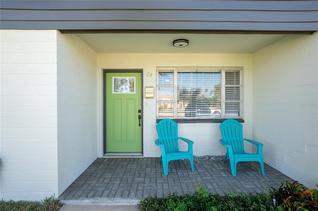 24 Berkley Road Ormond Beach, FL 32176 - Photo 3 of 44 a view of a chair and table in the porch