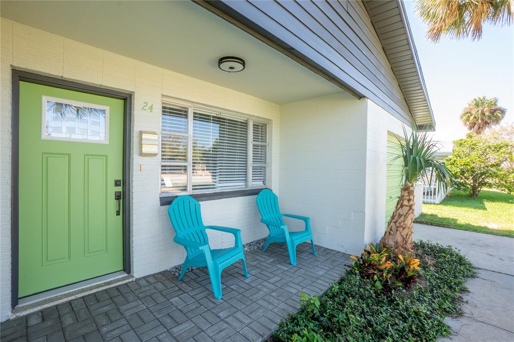 24 Berkley Road Ormond Beach, FL 32176 - Photo 4 of 44 a view of a backyard with a table and chairs and potted plants