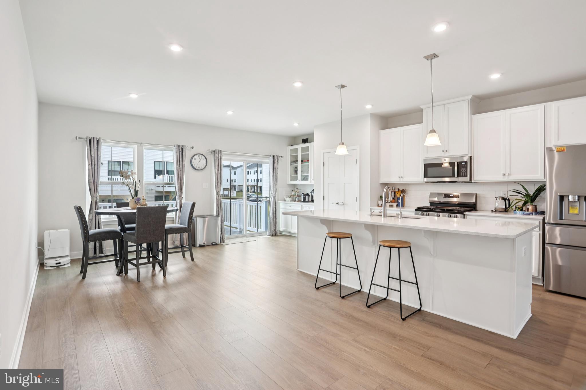 47 Rosemary Way Mount Laurel, NJ 08054 - Photo 15 of 47 a kitchen with stainless steel appliances granite countertop a stove top oven a sink a dining table and chairs with wooden floor