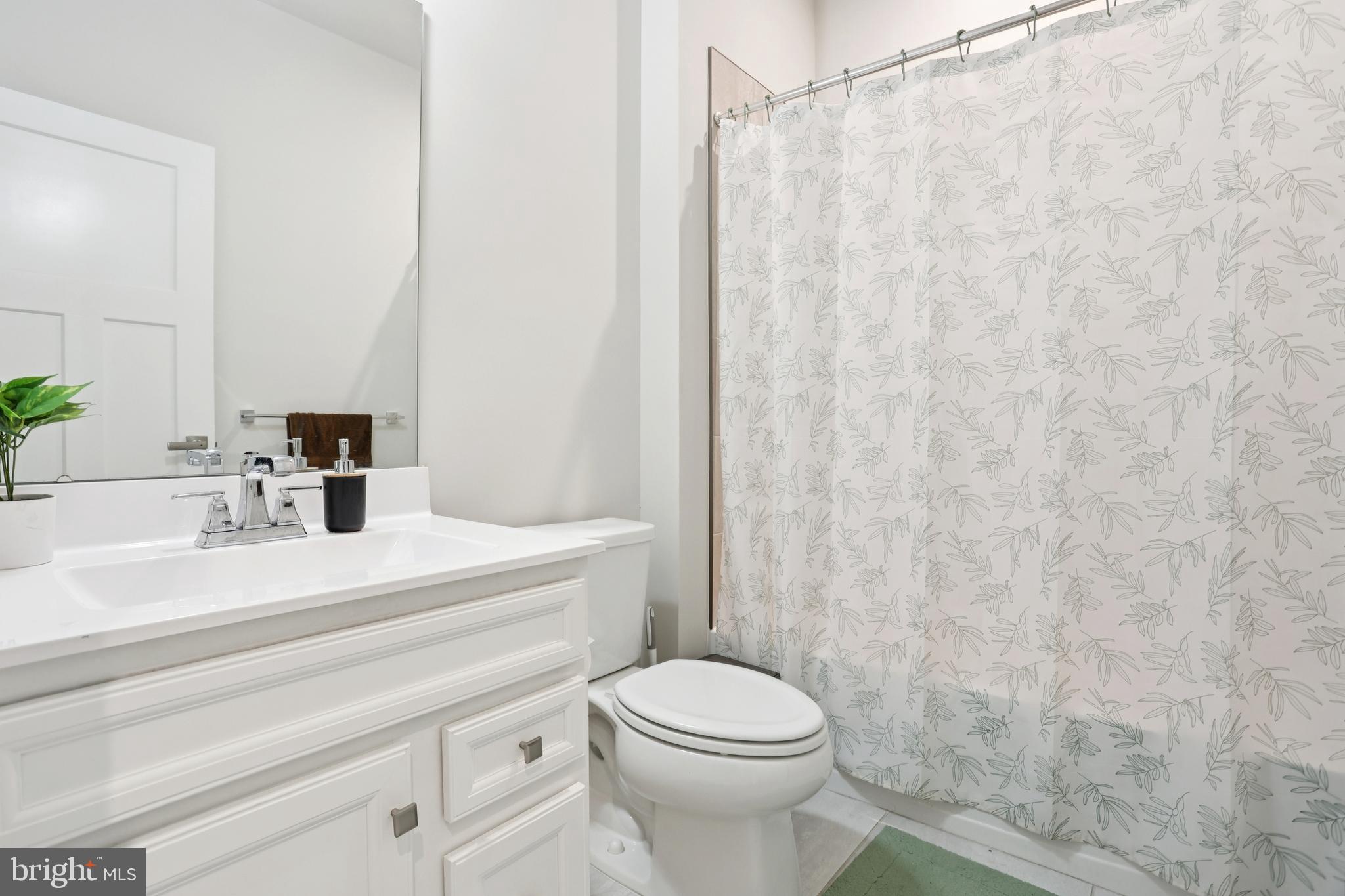 47 Rosemary Way Mount Laurel, NJ 08054 - Photo 25 of 47 a bathroom with a white toilet sitting next to a white sink and a shower curtain