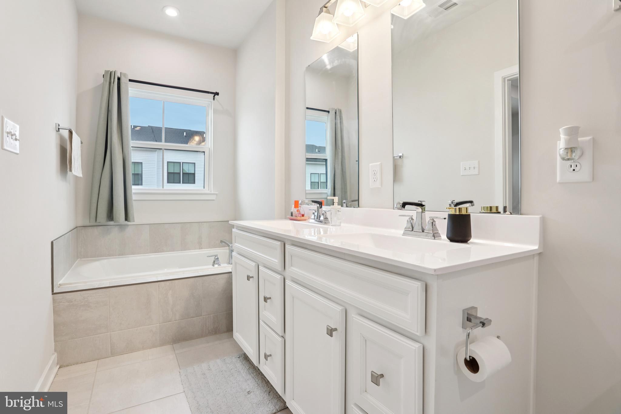 47 Rosemary Way Mount Laurel, NJ 08054 - Photo 34 of 47 a bathroom with a tub a double vanity sink a window and mirror