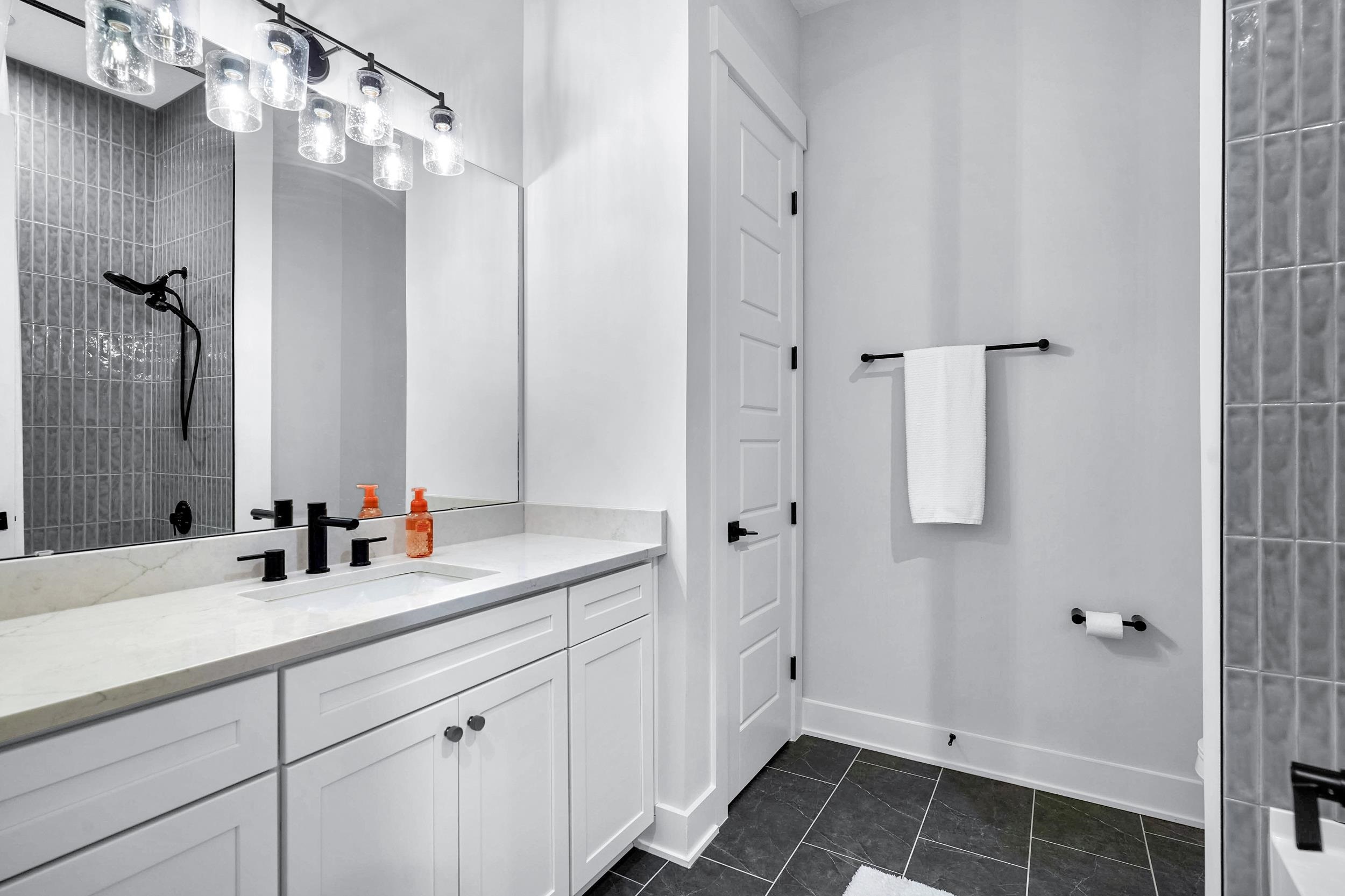Bathroom with vanity and dark tile patterned flooring