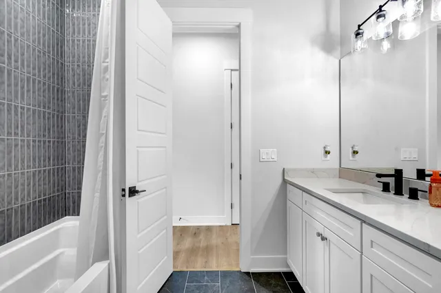 a bathroom with a sink a mirror and a bathtub
