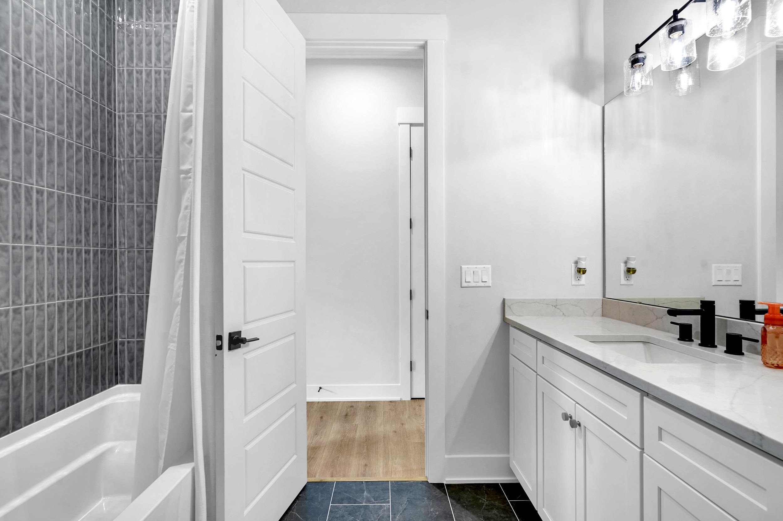 64 Oak Cluster Lane St. Augustine, FL 32092 - Photo 13 of 59 a bathroom with a sink a mirror and a bathtub