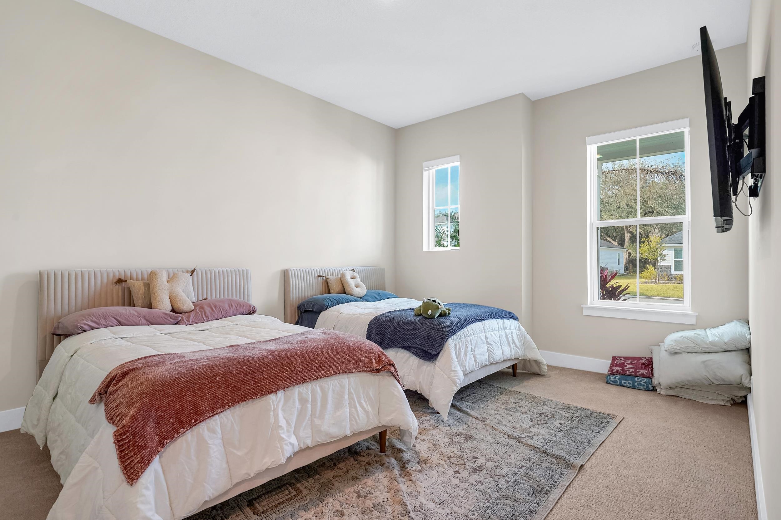 64 Oak Cluster Lane St. Augustine, FL 32092 - Photo 16 of 59 a bedroom with two beds and a large window