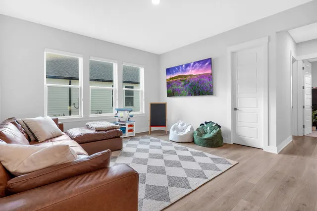 a living room with furniture and view of kitchen
