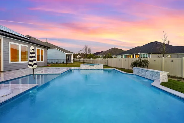 a view of a house with pool and a yard