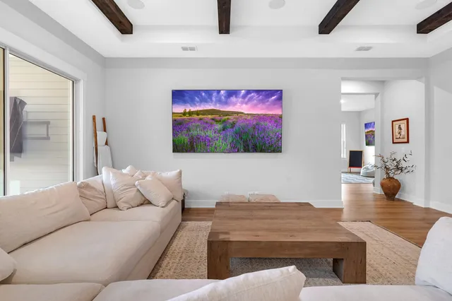 a living room with furniture and a chandelier