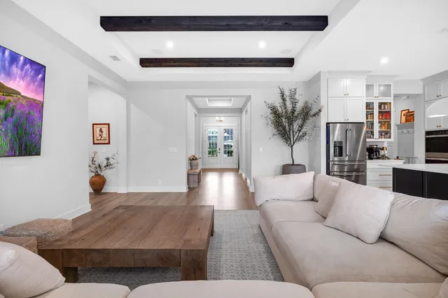 a living room with a couch and a view of kitchen