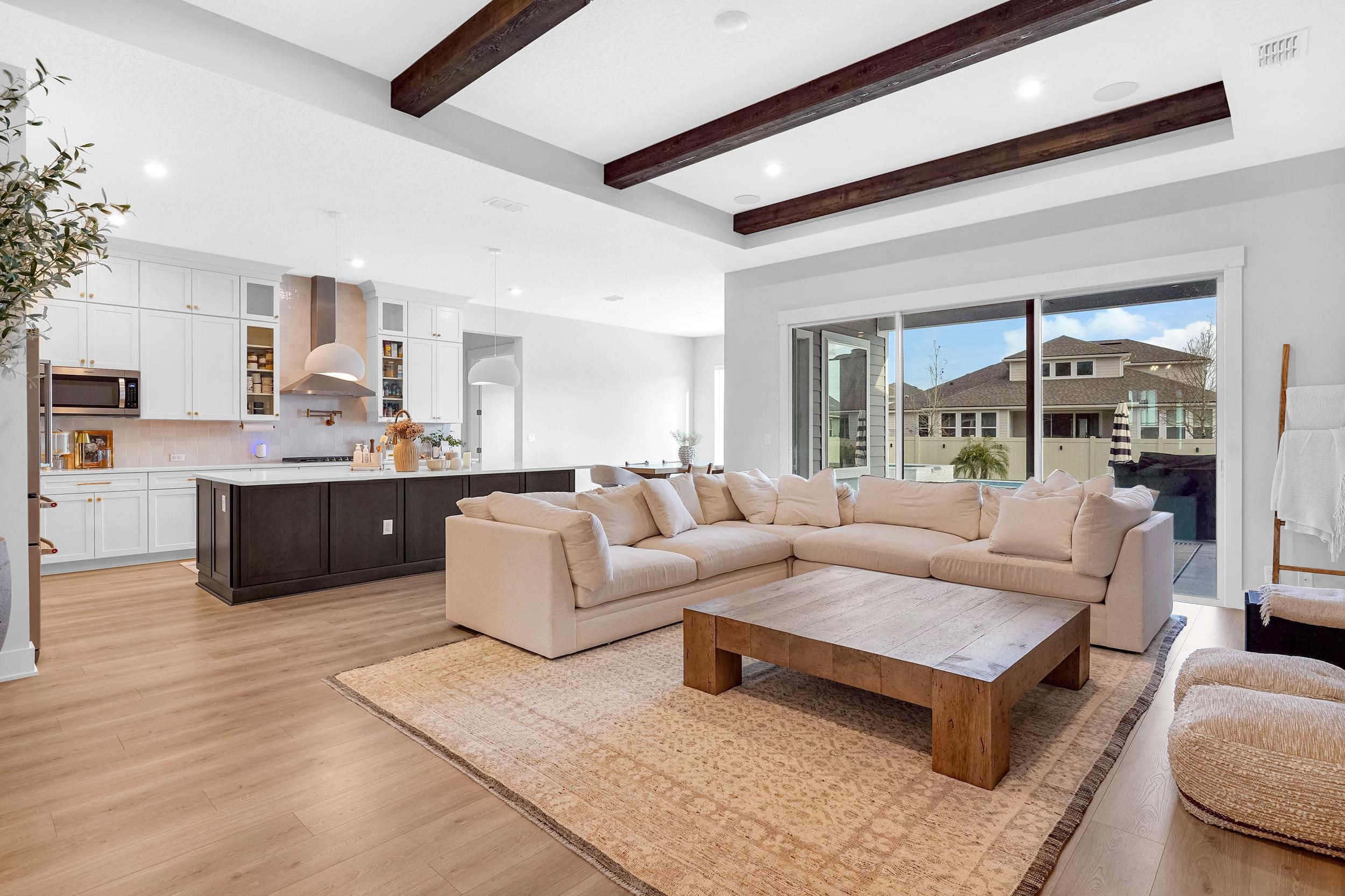 64 Oak Cluster Lane St. Augustine, FL 32092 - Photo 23 of 59 a living room with a couch and a view of kitchen