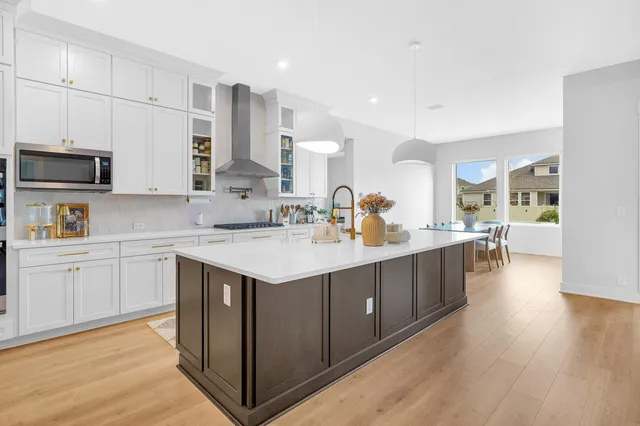 a kitchen with cabinets appliances and a counter space