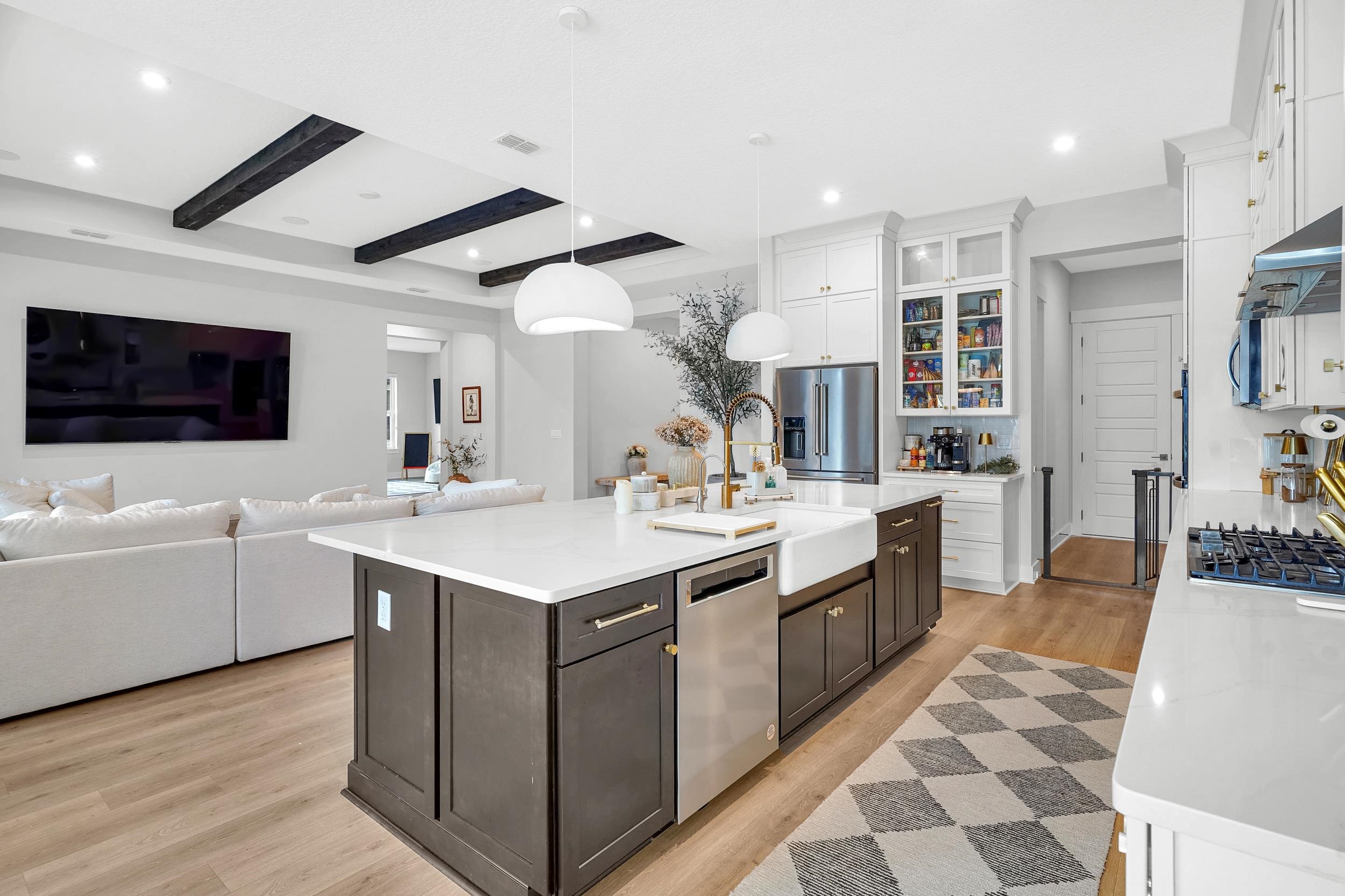 64 Oak Cluster Lane St. Augustine, FL 32092 - Photo 27 of 59 a large white kitchen with a sink and dishwasher a stove with wooden floor