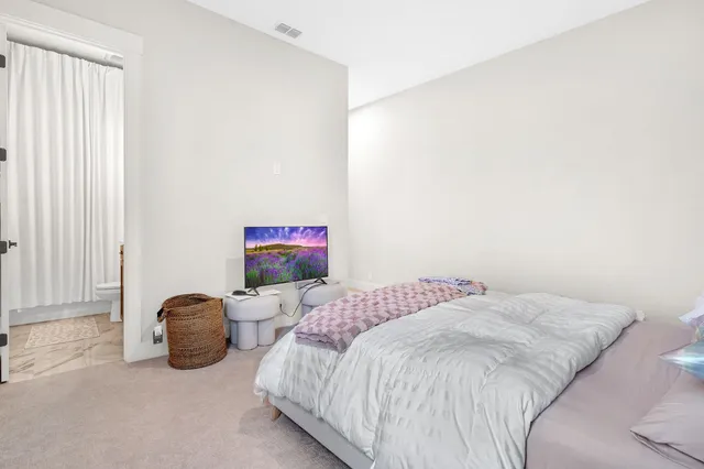 a bedroom with a bed chair and window