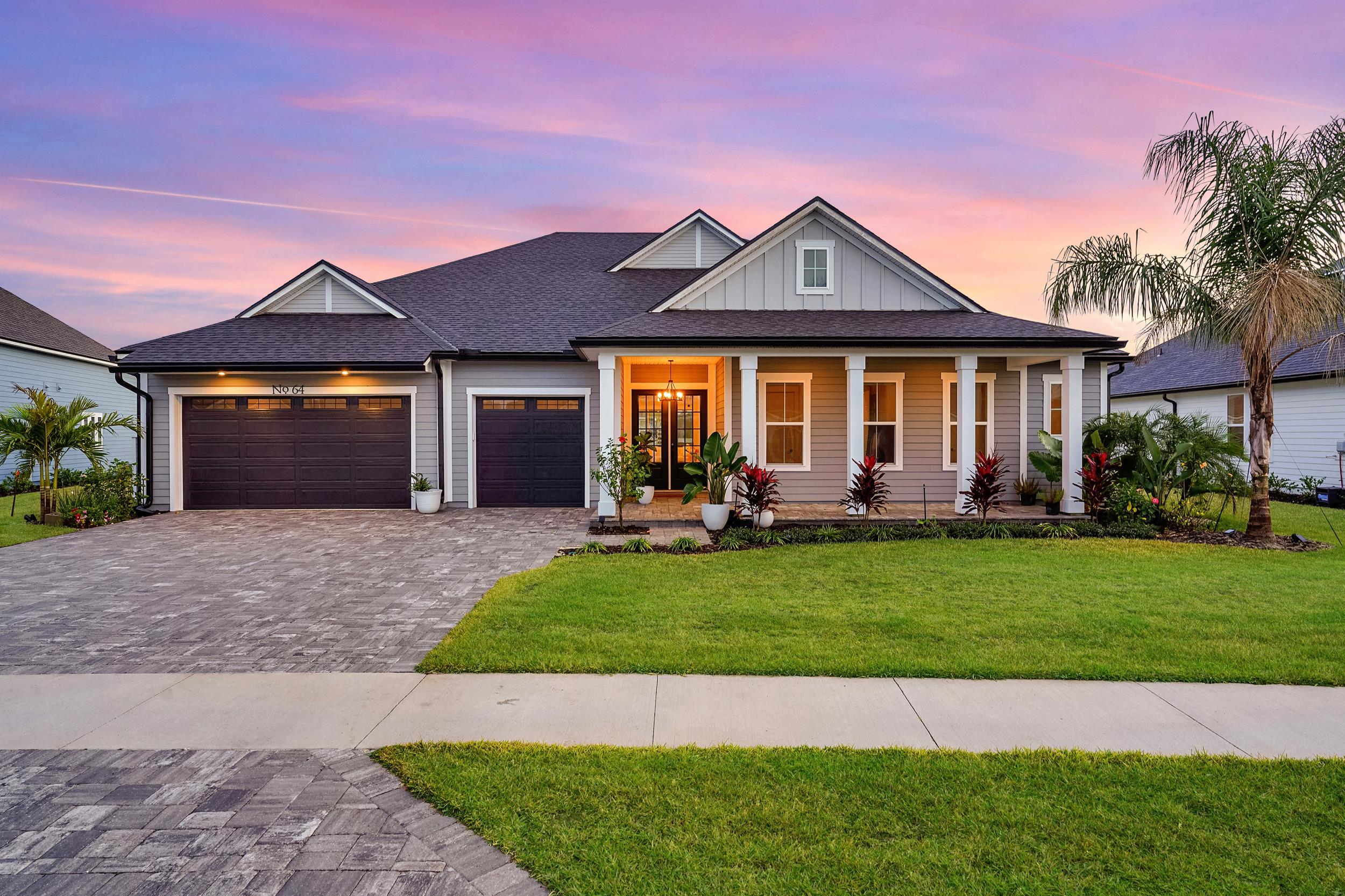 64 Oak Cluster Lane St. Augustine, FL 32092 - Photo 40 of 59 a front view of a house with a yard and garage