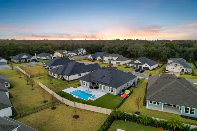 an aerial view of a house with a yard