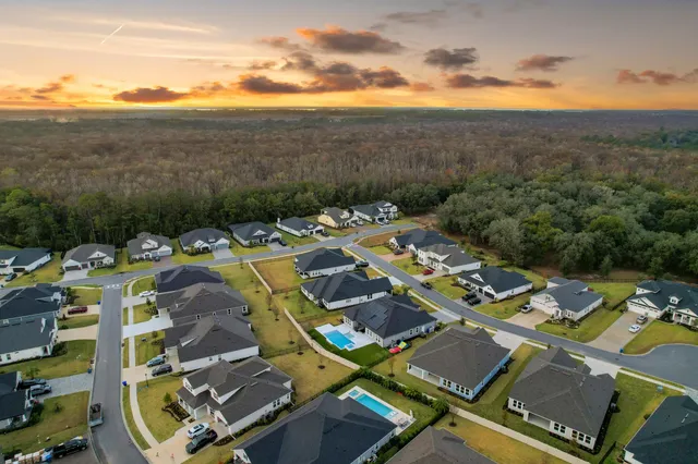 an aerial view of residential building and lake