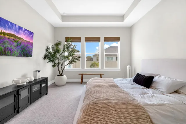 a large white kitchen with lots of counter space and a sink